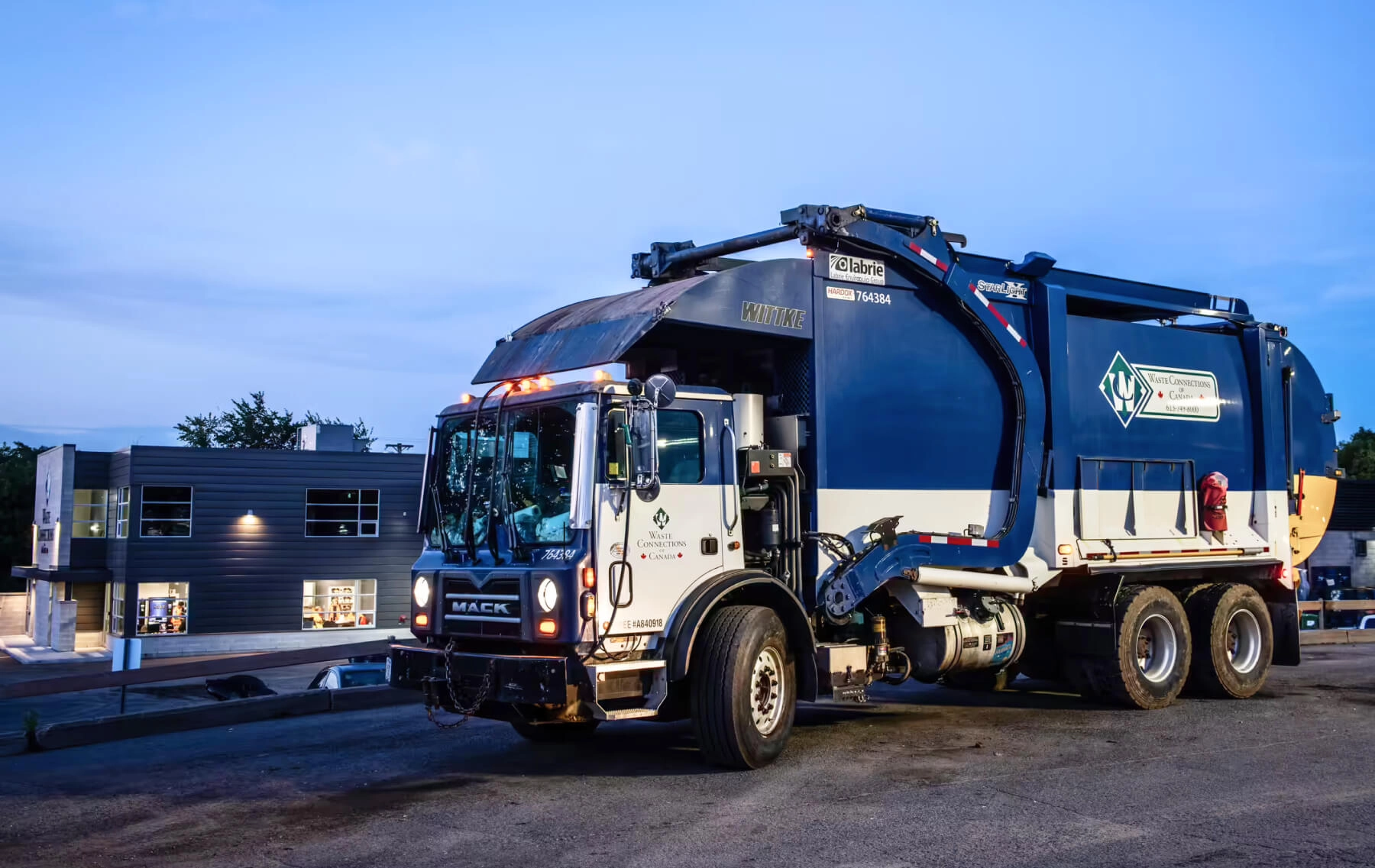 A Waste Connections of Canada front-load collection truck